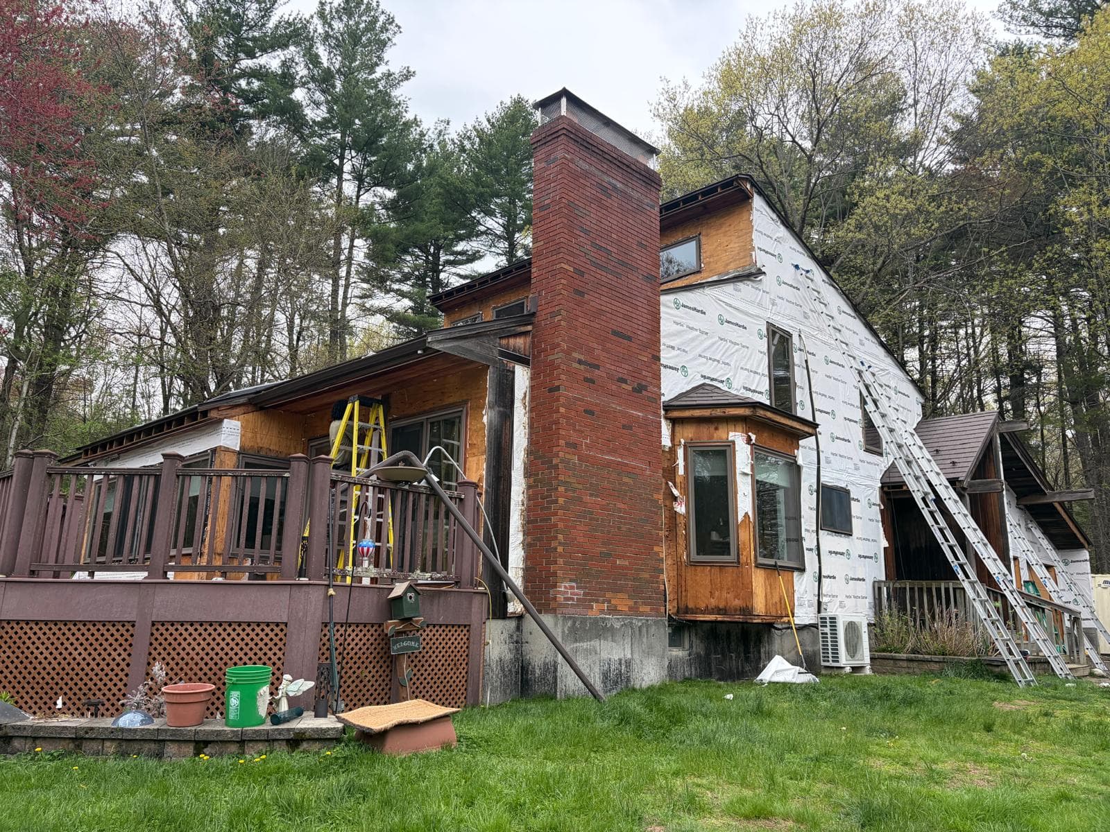 Carlisle Hardie install in progress — brick chimney with new white HardieWrap weather barrier going up