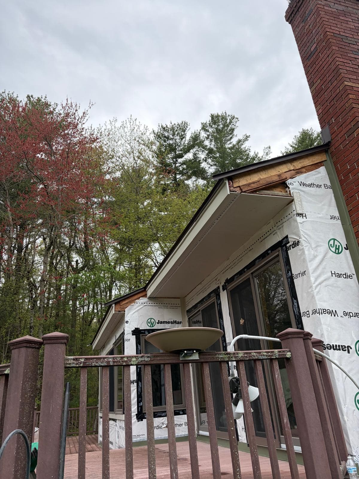 Close-up detail of Carlisle home porch area showing HardieWrap and trim work during install